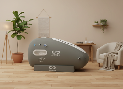 Gray AIRVIDA device on a wooden floor with a plant and chair in the background