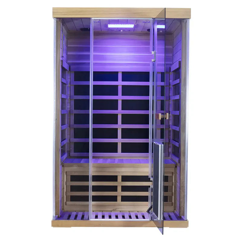 Infrared sauna with wooden interior and glass door, illuminated with purple light.