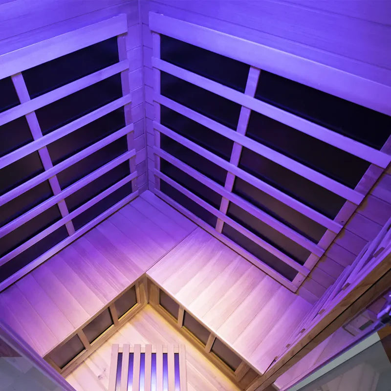 Infrared sauna with wooden benches and purple lighting