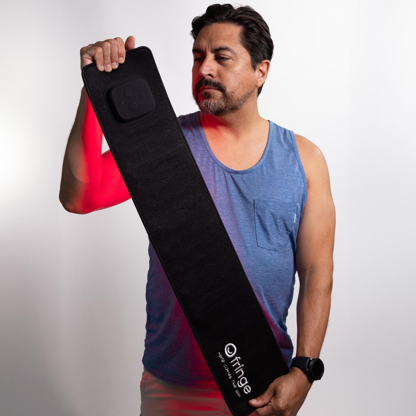 Man holding a black wrap with 'Fringe' branding against a white background