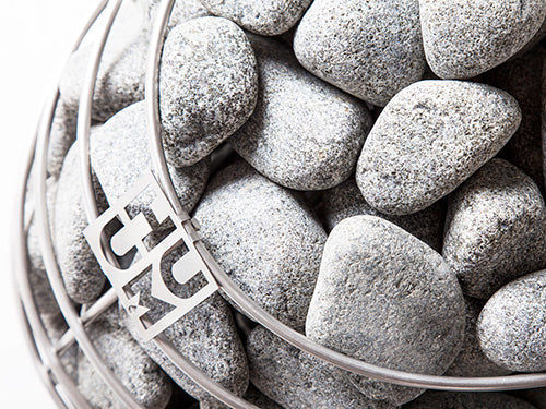Close-up of a bucket filled with gray stones, with a visible brand logo on the side.