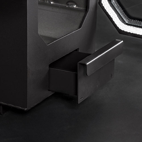 Close-up of a black ash tray drawer with metallic handle on a dark surface