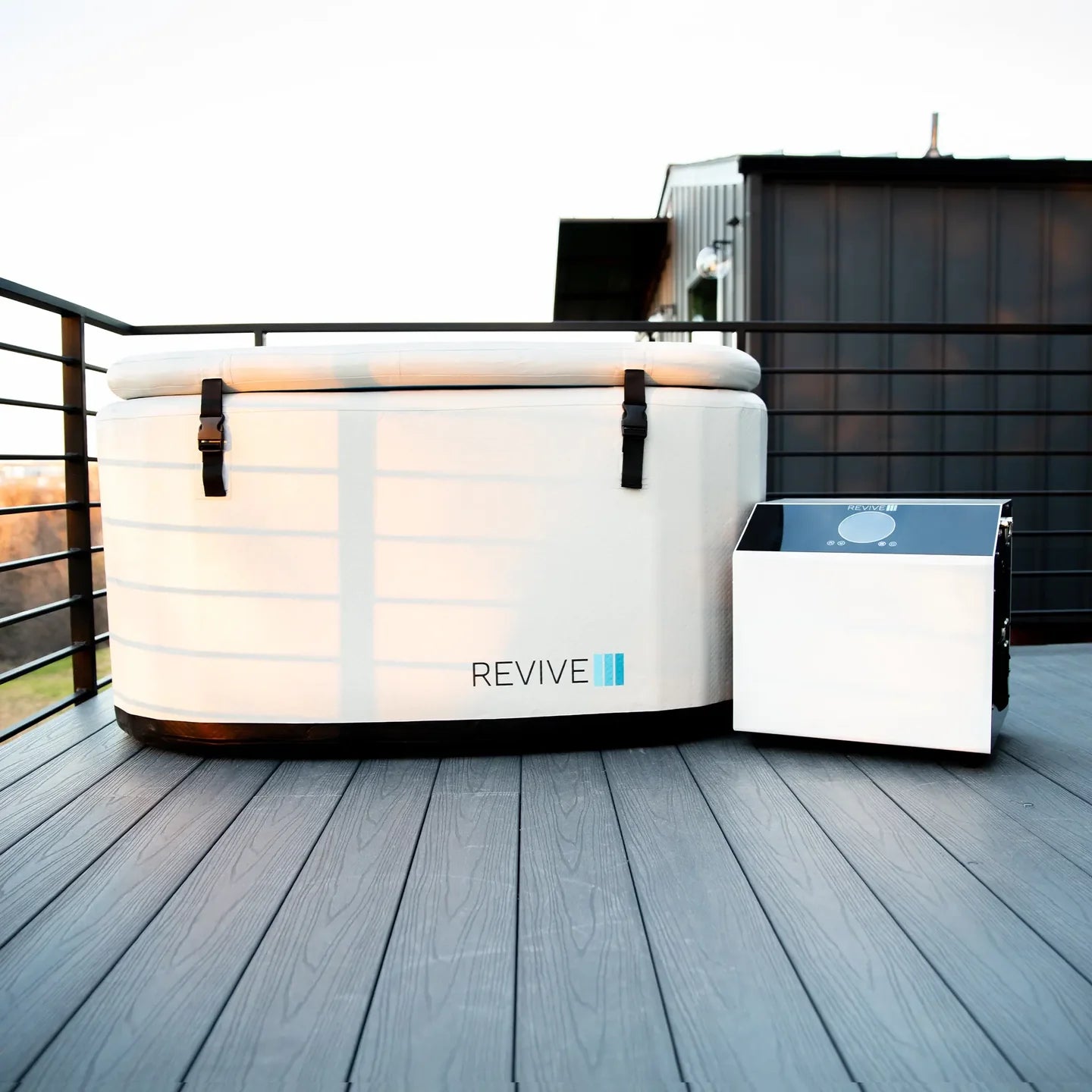 Luminous cold tub on a wooden deck with 'REVIVE' branding.