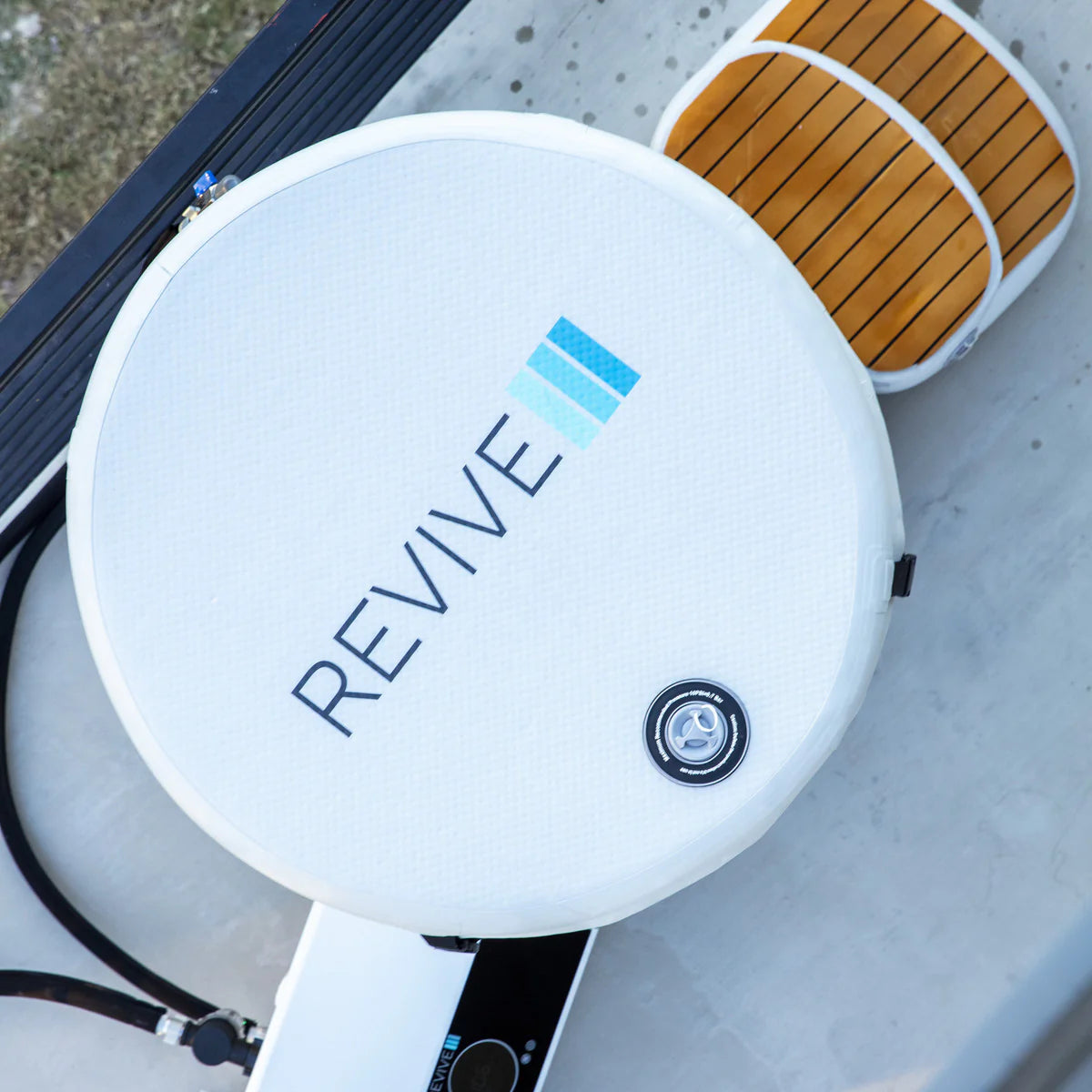 Cold tub  with 'REVIVE' branding on a gray surface