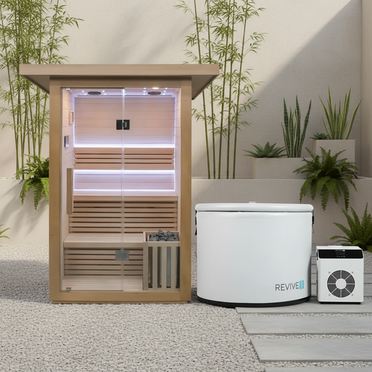 Traditional sauna with two white units labeled 'REVIVE' in a modern outdoor setting with plants.