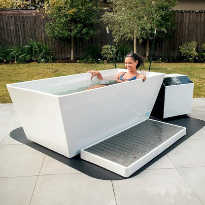 Person relaxing in a modern outdoor cold plunge with a garden background