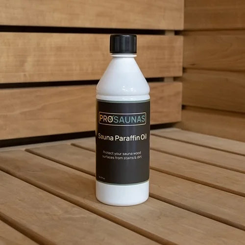 Bottle of ProSaunas Sauna Paraffin Oil on a wooden surface