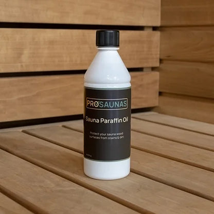 Bottle of ProSaunas Sauna Paraffin Oil on a wooden surface