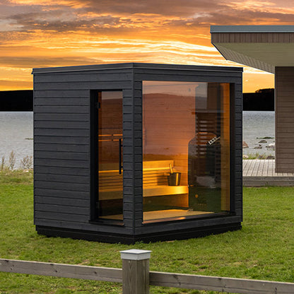 Modern outdoor sauna with a scenic sunset view over water