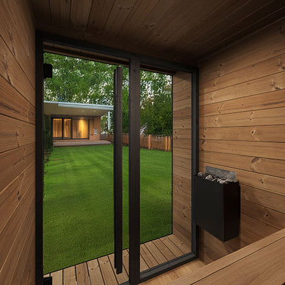 Wooden cabin with glass doors showing a view of a garden and house exterior.