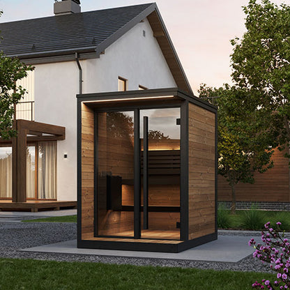 Modern outdoor sauna with wooden exterior and glass doors, set against a house and garden backdrop.