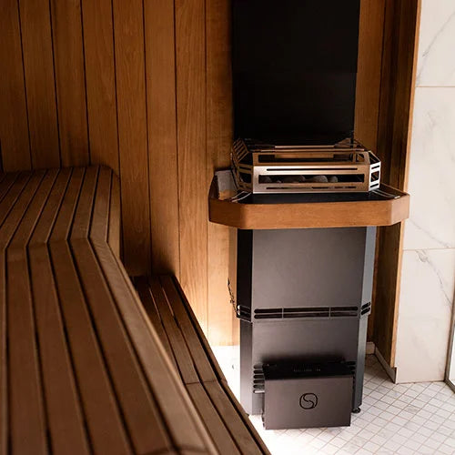 Saunum heater in a sauna surrounded by wood