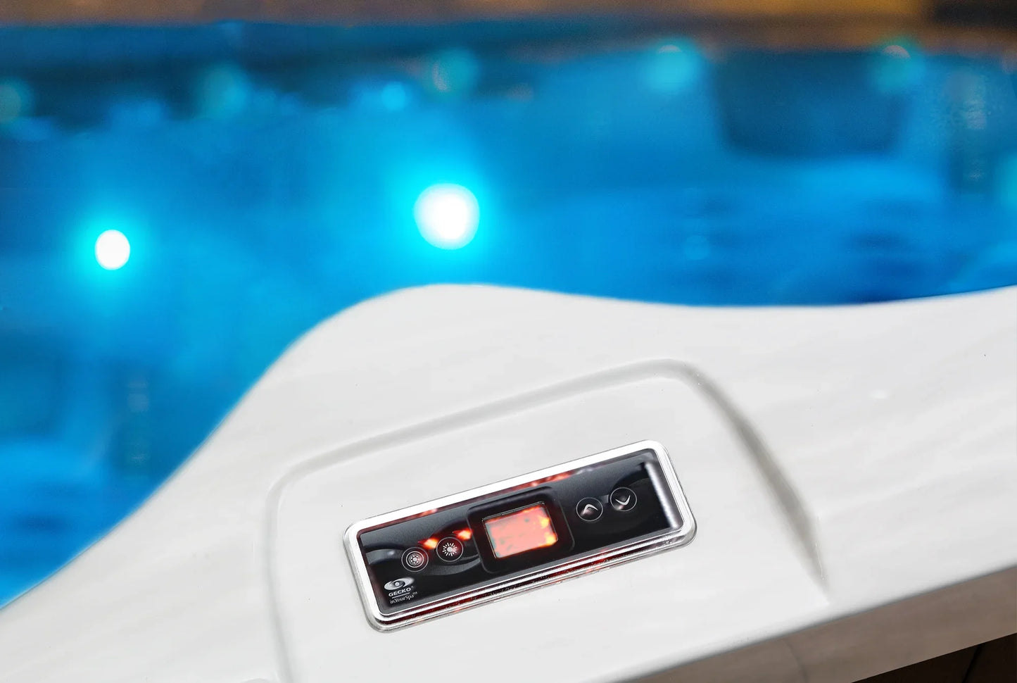 Control panel of a hot tub with blue water in the background